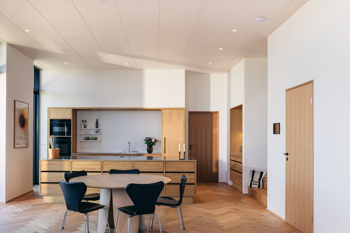 Arku akustikloft monteret i lys moderne bolig i køkkenet hvor panelerne absorbere lyd og gør rummet behageligt